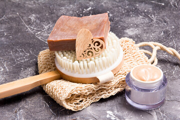 wooden brush with natural bristles for dry massage against cellulite, body scrub, home soap, knitted washcloth, eco friendly lifestyle, copy space