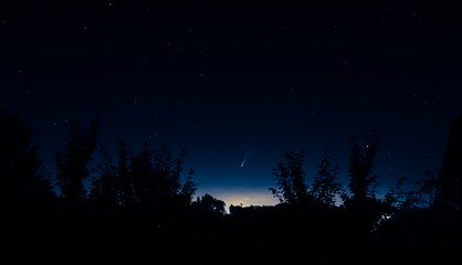 Naklejka premium 07.14.2020 Comet Neowise in the night sky over the belarusian countryside. An unusual astronomical phenomenon that is visible to the naked eye.