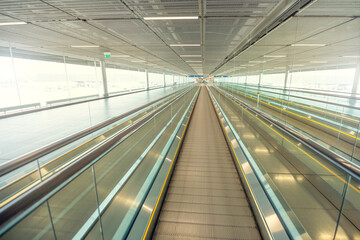 Empty airport terminal due to coronavirus pandemic and suspended airline flights. Empty airport terminal. Mechanical corridor without people.