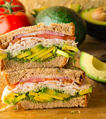Sandwiches. Tuna Salad. Chicken Salad. Served on slices of white, rye, and whole grain bread with lettuce and tomato. Traditional American lunch or snack favorite. 