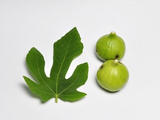 Figs fruit or ficus carica with green leaf isolated on white background