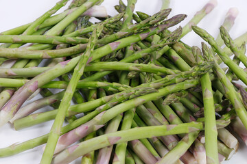 Fresh group of green asparagus on white background