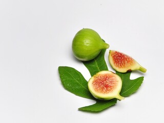 Figs fruit or ficus carica with green leaf isolated on white background