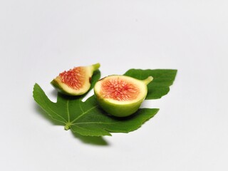 Figs fruit or ficus carica with green leaf isolated on white background