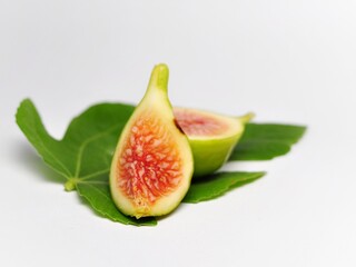 Figs fruit or ficus carica with green leaf isolated on white background