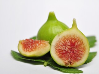 Figs fruit or ficus carica with green leaf isolated on white background