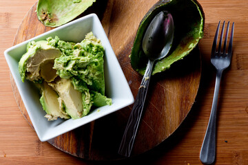 Spicy Guacamole served in crispy taco shells with salsas, cilantro and lime. Avocados diced and mixed with lemon and lime juices. Classic Tex-Mex, Mexican or American restaurant appetizer favorite.