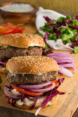 Hamburger made with lamb meat. Lamb burger. Classic traditional greek variation of the classic american burger tradition. seasoned lamb meat with feta cheese, red onion and greek mayo. 
