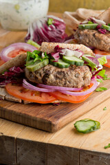 Hamburger made with lamb meat. Lamb burger. Classic traditional greek variation of the classic american burger tradition. seasoned lamb meat with feta cheese, red onion and greek mayo. 