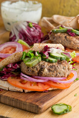 Hamburger made with lamb meat. Lamb burger. Classic traditional greek variation of the classic american burger tradition. seasoned lamb meat with feta cheese, red onion and greek mayo. 