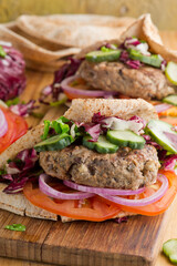 Hamburger made with lamb meat. Lamb burger. Classic traditional greek variation of the classic american burger tradition. seasoned lamb meat with feta cheese, red onion and greek mayo. 