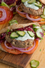 Hamburger made with lamb meat. Lamb burger. Classic traditional greek variation of the classic american burger tradition. seasoned lamb meat with feta cheese, red onion and greek mayo. 