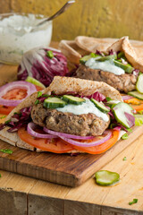 Hamburger made with lamb meat. Lamb burger. Classic traditional greek variation of the classic american burger tradition. seasoned lamb meat with feta cheese, red onion and greek mayo. 