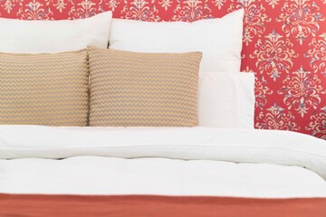 Close - up Pillows and cushions laid on the bed