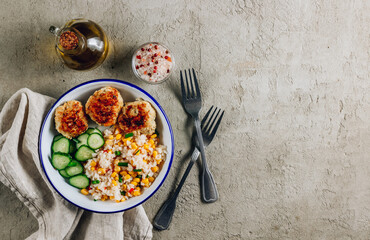 Homemade chicken bowl with rice, corn and cucumber. Healthy balanced eating for lunch.