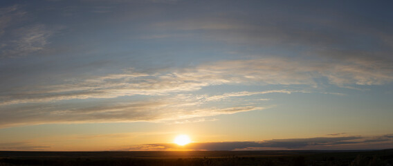 Epic landscape at sunset. Tragic gloomy sky. Fantastic skies on the planet earth. Crimson twilight. Panorama.