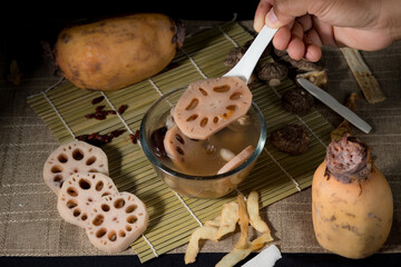 Lotus root soup with beans in a bowl and Chinese herbs, shiitake mushroom, lotus root