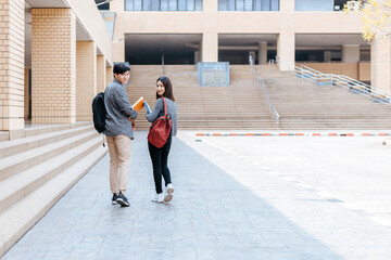 high school students hold book and laptop in the university. Education concept.