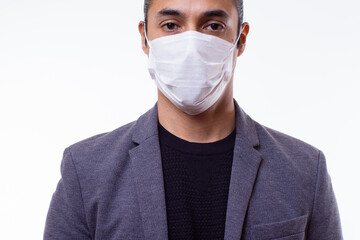Portrait of young Latino businessman with medical mask. Latin teacher with medical mask. White background. Coronavirus concept
