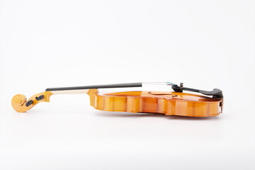 Wooden violins lie flat against a white background.