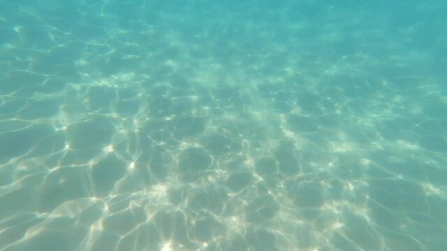 Snorkelling on blue turquoise water edge in Costa Brava, Mediterranean coast beach with sea waves