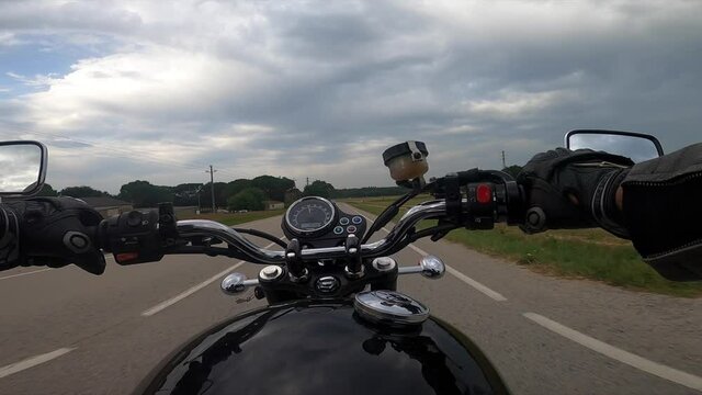Riding a black motorcycle on a tarmac road