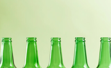 An empty wine bottle on a green background