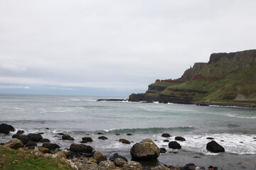 Fototapeta na wymiar The Giant's Causeway is an area of about 40,000 interlocking basalt columns, the result of an ancient volcanic fissure eruption. It is located in County Antrim on the north coast of Northern Ireland