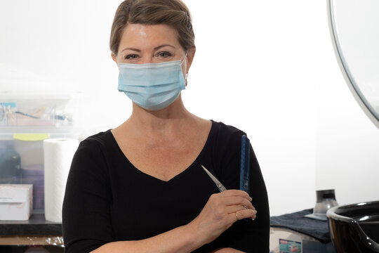 Female Salon Worker Wearing Facial Mask Because Of Covid 19