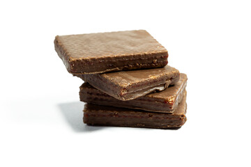 Macro photo of Chocolate bar. Broken pieces over white background