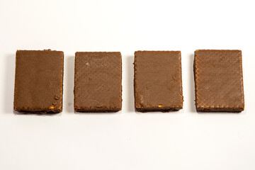 Macro photo of Chocolate bar. Broken pieces over white background
