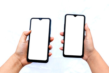 The hand is holding the white screen, the mobile phone is isolated on a white background with the...