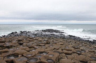 Fototapeta na wymiar The Giant's Causeway is an area of about 40,000 interlocking basalt columns, the result of an ancient volcanic fissure eruption. It is located in County Antrim on the north coast of Northern Ireland