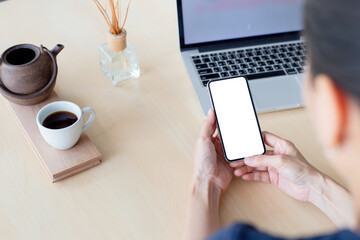 cell phone mockup image blank white screen.woman hand holding texting using mobile on desk at coffee shop.background empty space for advertise.work people contact marketing business,technology