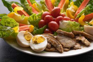 Fresh chicken salad with crab sticks and boiled eggs.