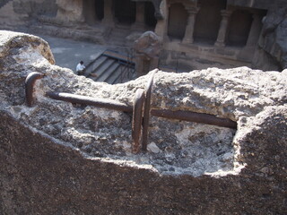 A stone wall with iron bars visible, Ellora Caves, Aurangabad, Maharashtra, Western India, India