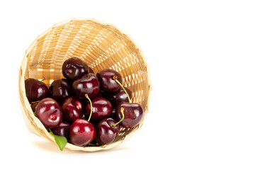 Red cherries in a weave basket.