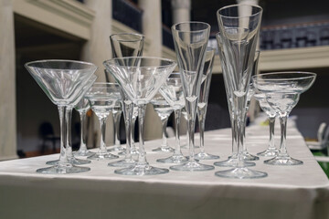 Various empty glasses on the table with blurred luxury interior