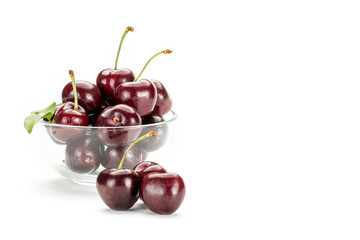  Red cherries in a clear glass cup.