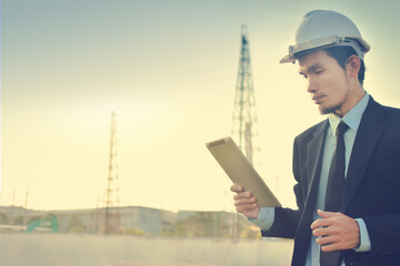 Asian Man Business use tablet check on site construction