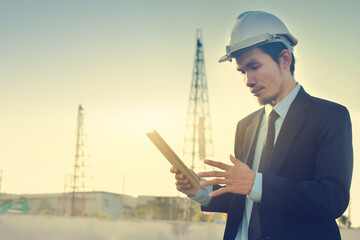 Asian Man Business use tablet check on site construction