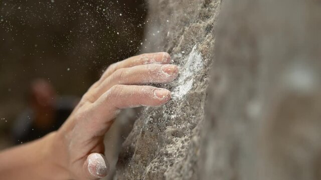 SLOW MOTION, MACRO, DOF: Unrecognizable female rock climber's hand slips while trying to hold on to a natural sloper hold. Fit woman with chalked up hands falls after trying to grip a sloper hold.
