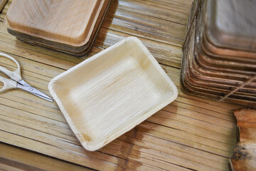 Eco friendly disposable tableware from palm leaf or betel nut , zero waste environment concept Natural eco-friendly food packaging disposable utensils with dish plate