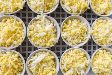 Cheese on white bowl - cheddar cheese grated for cooked food