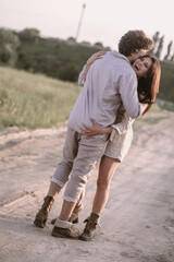 Happy couple stands on a road