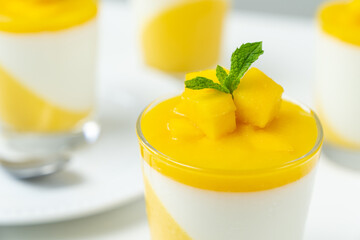 Italian dessert mango panna cotta decorated with fresh mango and mint