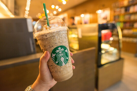 Jakarta, Indonesia : July-19-2018 : Someone hand holding a cup of Java Chip Frappuccino in Starbucks coffee shop.