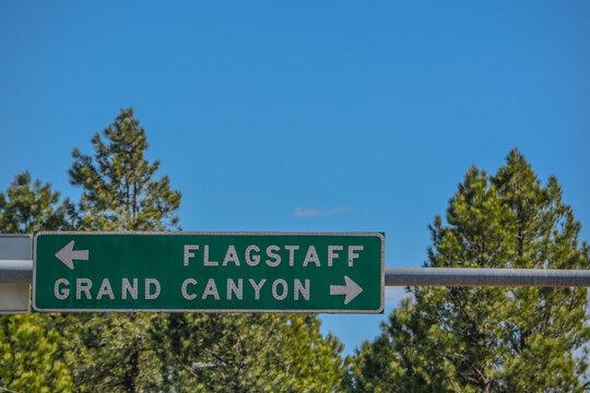 Flagstaff and Grand Canyon Road Sign in the Arizona Pine Forest. Flagstaff, Arizona