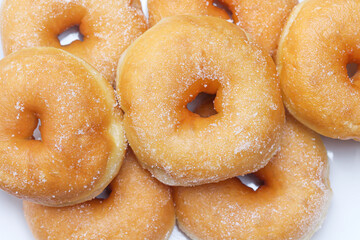 Fresh donuts sprinkles with sugar top view tasty food background