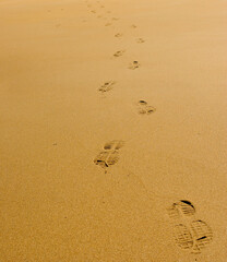 Fototapeta na wymiar Human Footprints in yellow sand